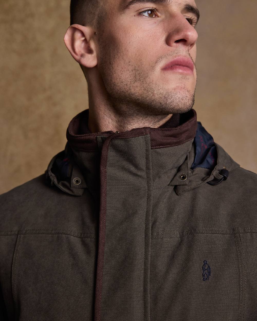 Olive Coloured Jack Murphy Emmet Waterproof Long Coat on indoor background 