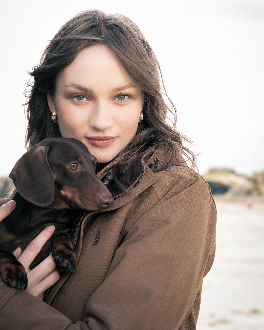Camel Coloured Jack Murphy Erin Long Waterproof Coat on outdoor background 