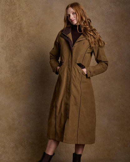 Camel Coloured Jack Murphy Erin Long Waterproof Coat on indoor background 