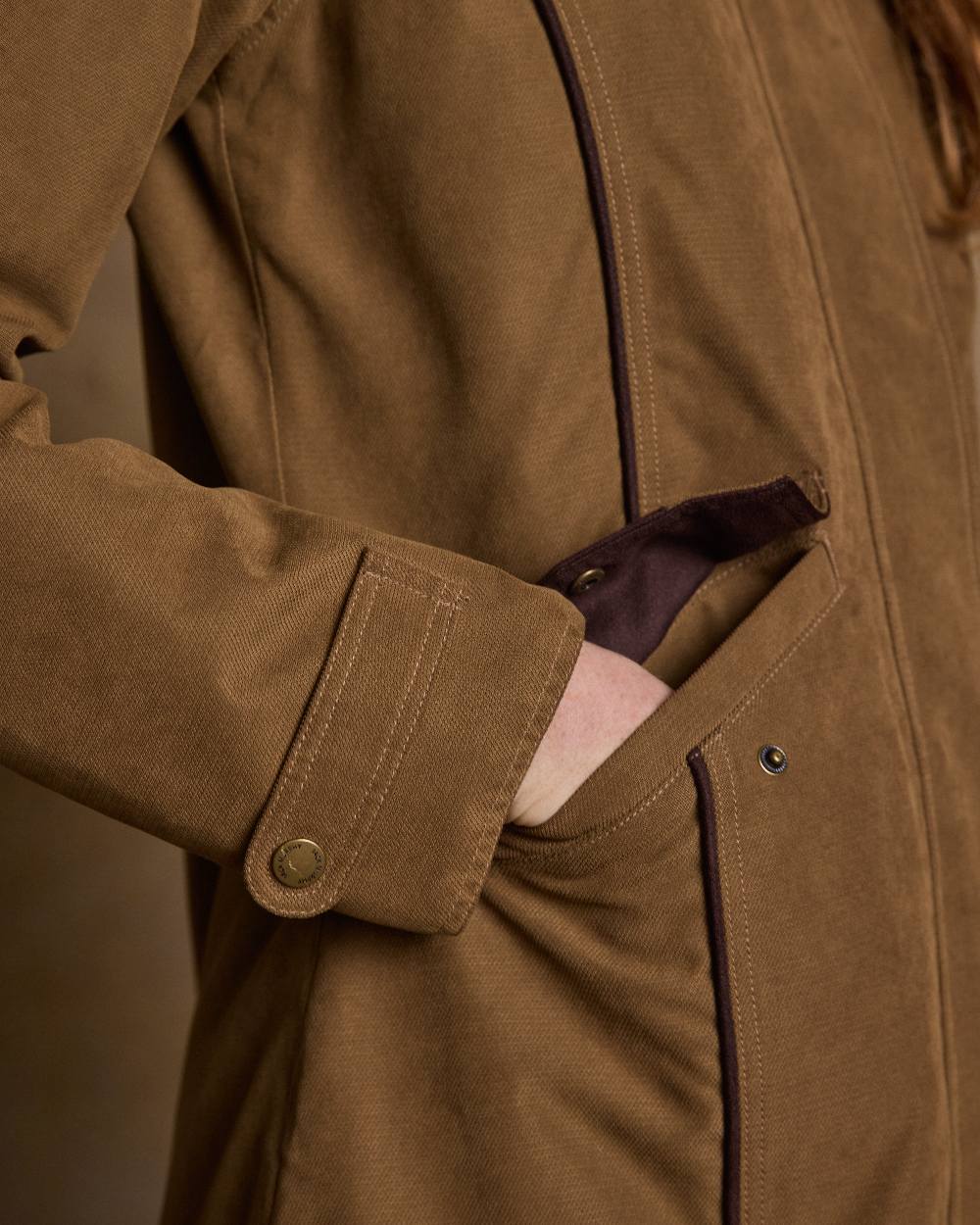Camel Coloured Jack Murphy Erin Long Waterproof Coat on indoor background 