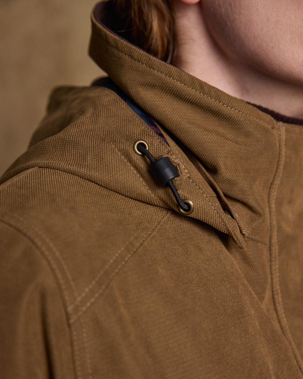 Camel Coloured Jack Murphy Erin Long Waterproof Coat on indoor background 