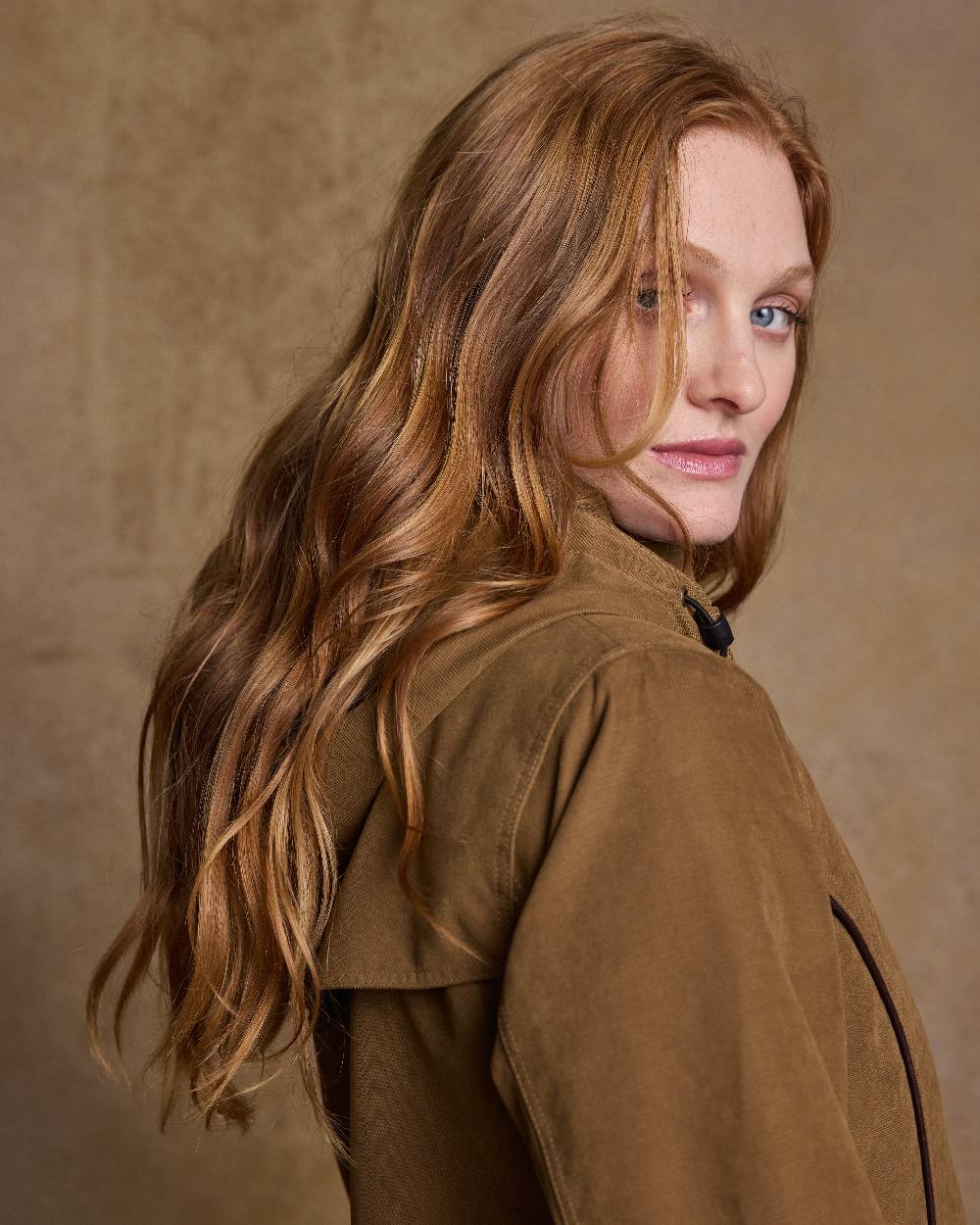 Camel Coloured Jack Murphy Erin Long Waterproof Coat on indoor background 