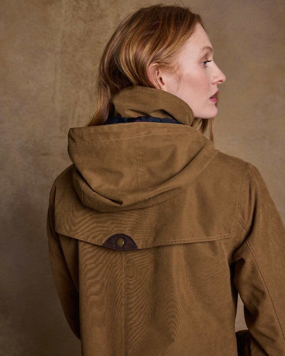 Camel Coloured Jack Murphy Erin Long Waterproof Coat on indoor background 