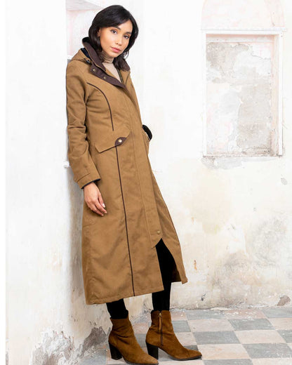 Camel coloured Jack Murphy Erin Long Waterproof Coat on wall background 