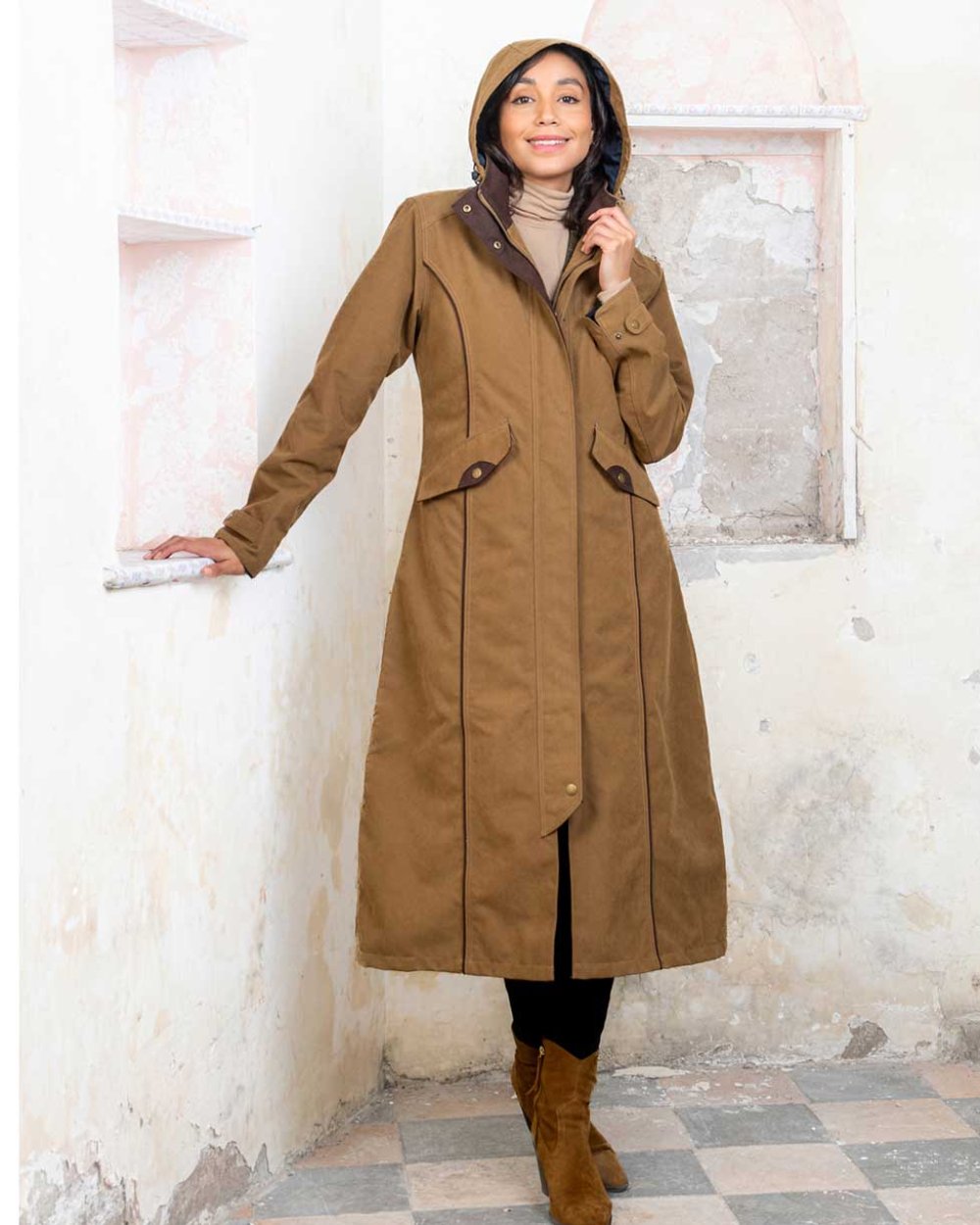 Camel coloured Jack Murphy Erin Long Waterproof Coat on wall background 