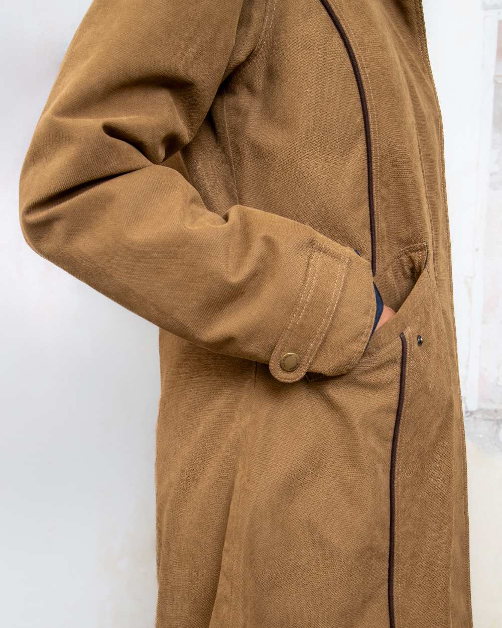 Camel coloured Jack Murphy Erin Long Waterproof Coat on wall background 