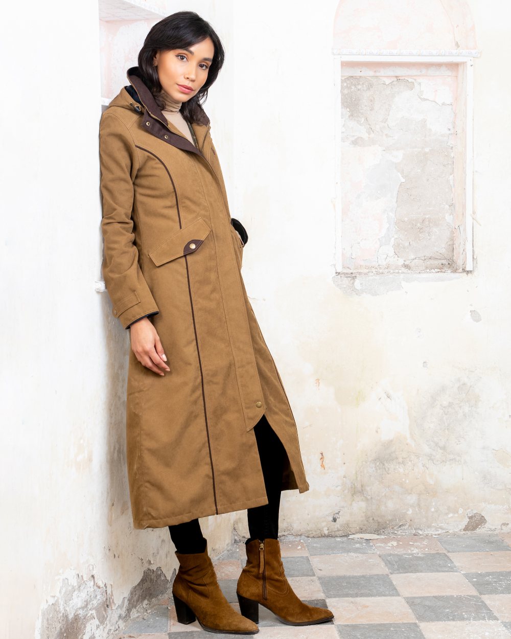 Camel coloured Jack Murphy Erin Long Waterproof Coat on wall background 