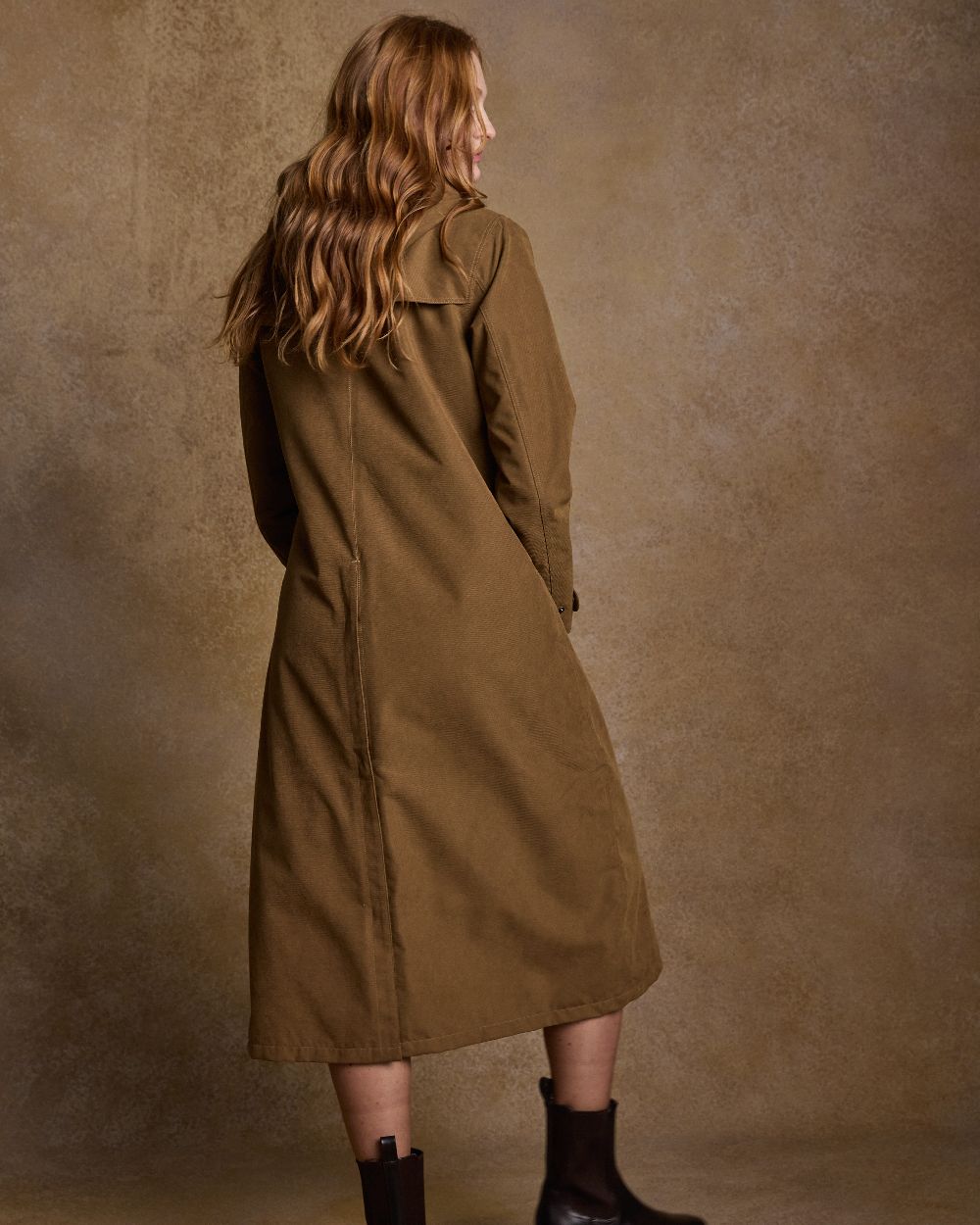 Camel Coloured Jack Murphy Erin Long Waterproof Coat on indoor background 