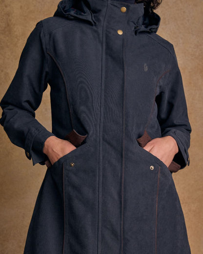 Heritage Navy coloured Jack Murphy Erin Long Waterproof Coat on wall background 