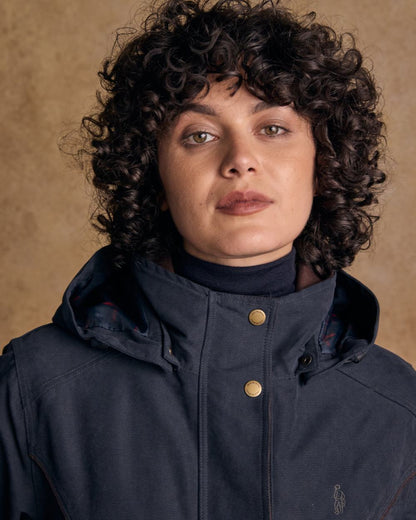 Heritage Navy coloured Jack Murphy Erin Long Waterproof Coat on wall background 