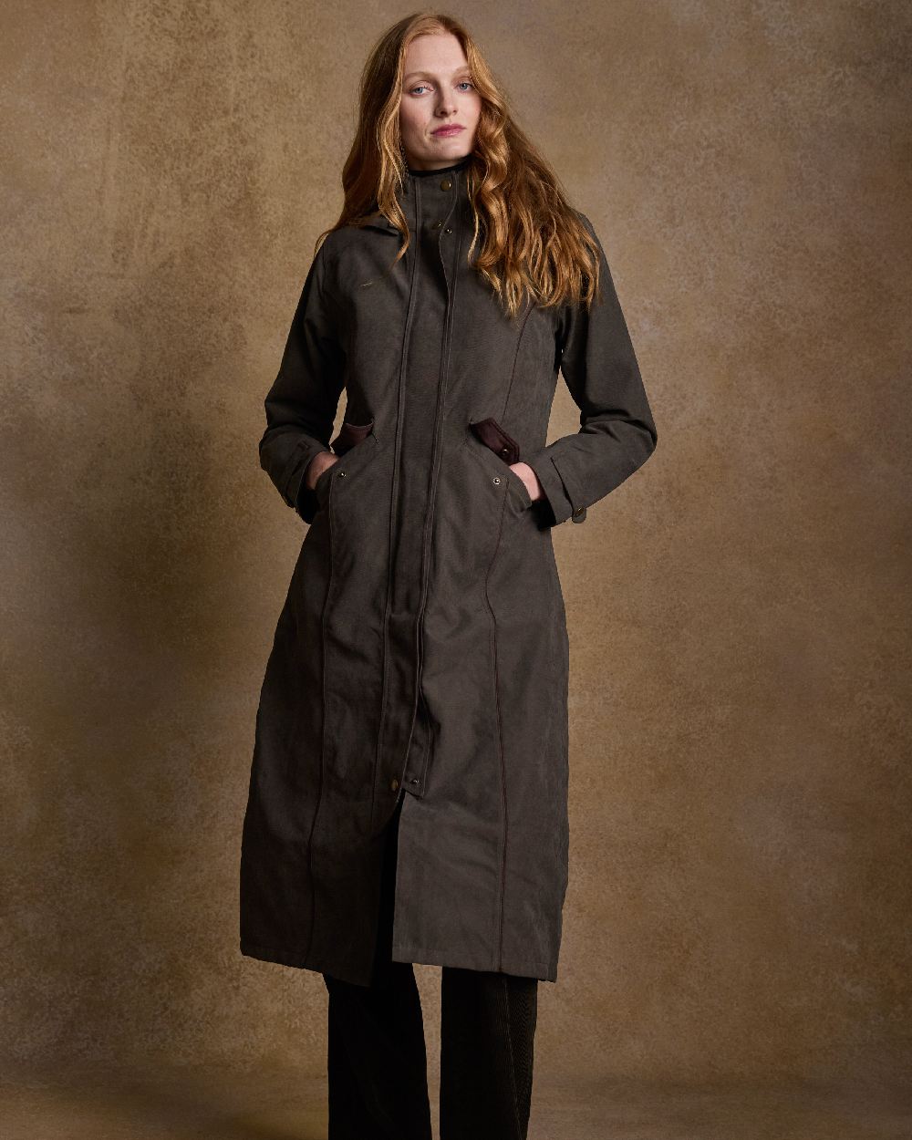 Olive Coloured Jack Murphy Erin Long Waterproof Coat on indoor background 