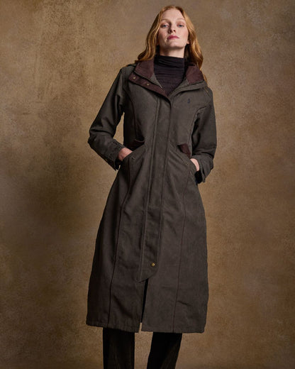 Olive Coloured Jack Murphy Erin Long Waterproof Coat on indoor background 