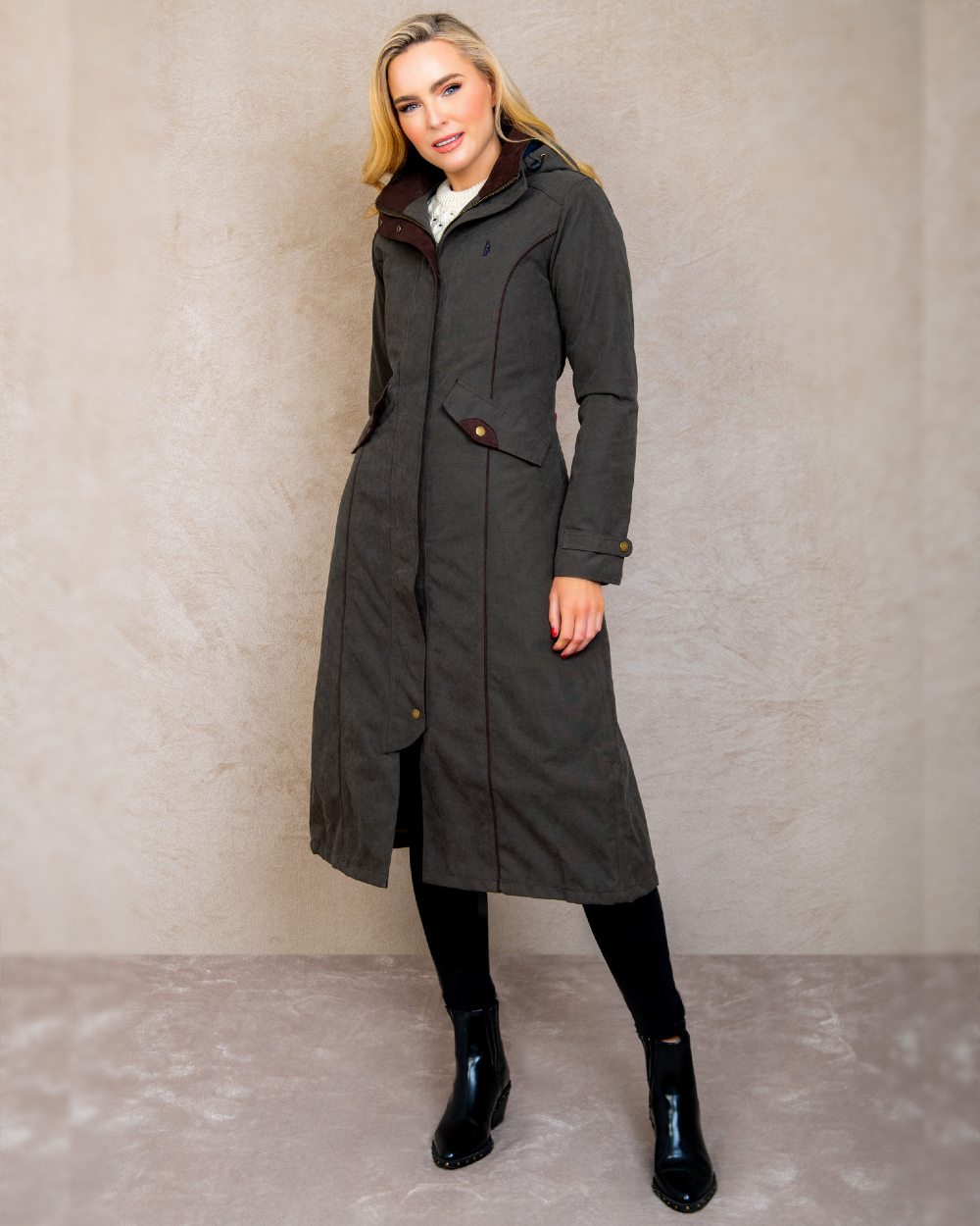 Olive coloured Jack Murphy Erin Long Waterproof Coat on wall background 