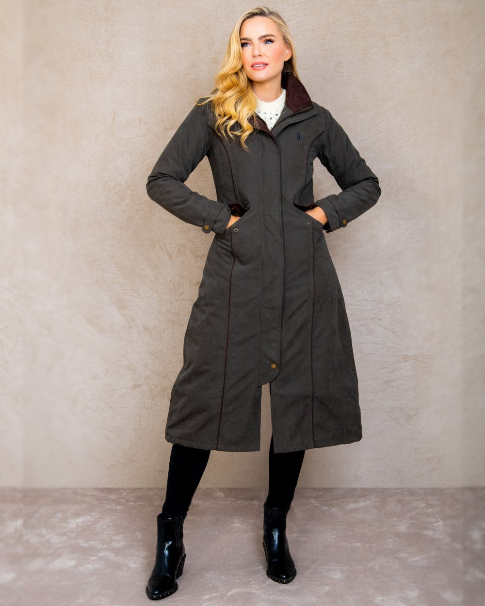 Olive coloured Jack Murphy Erin Long Waterproof Coat on wall background 