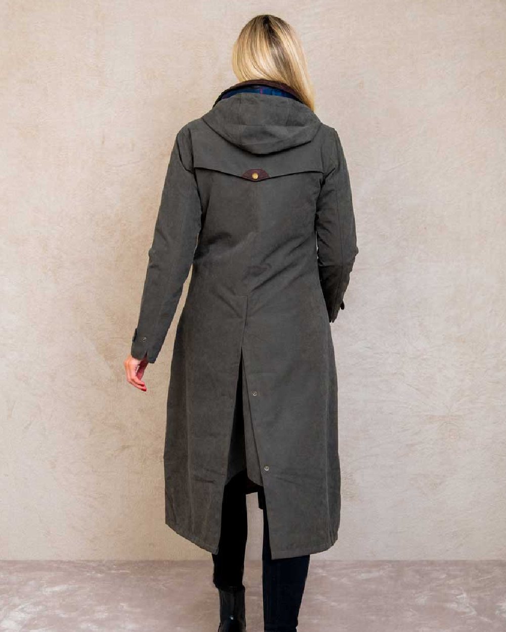 Olive coloured Jack Murphy Erin Long Waterproof Coat on wall background 