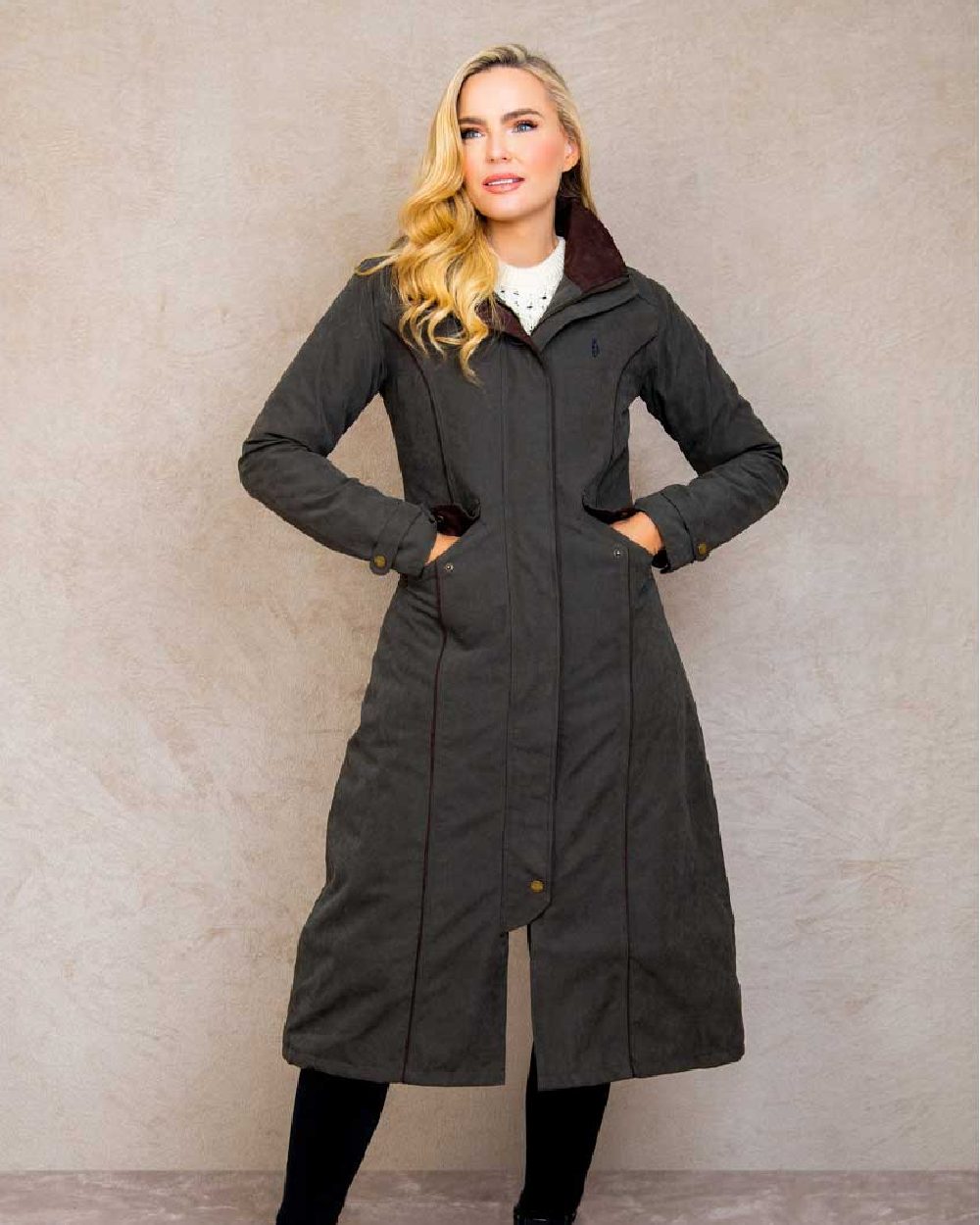 Olive coloured Jack Murphy Erin Long Waterproof Coat on wall background 