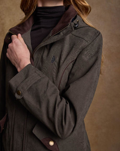 Olive Coloured Jack Murphy Erin Long Waterproof Coat on indoor background 