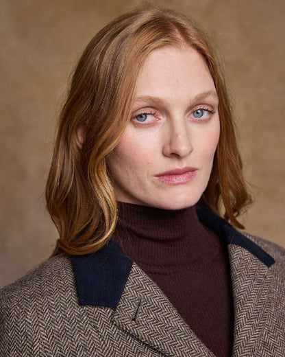 Light Tan Herringbone Coloured Jack Murphy Isabella Tweed Coat on indoor background 