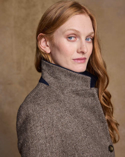 Light Tan Herringbone Coloured Jack Murphy Isabella Tweed Coat on indoor background 