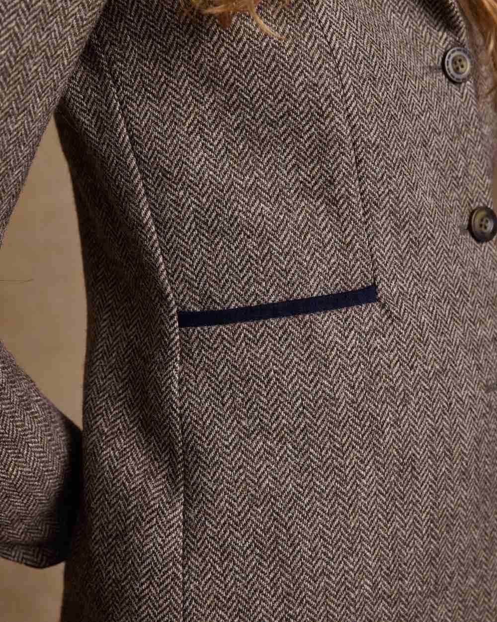 Light Tan Herringbone Coloured Jack Murphy Isabella Tweed Coat on indoor background 