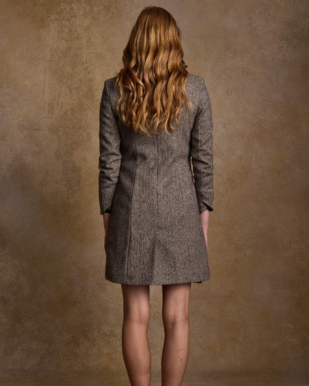 Light Tan Herringbone Coloured Jack Murphy Isabella Tweed Coat on indoor background 