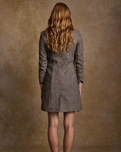 Light Tan Herringbone Coloured Jack Murphy Isabella Tweed Coat on indoor background 