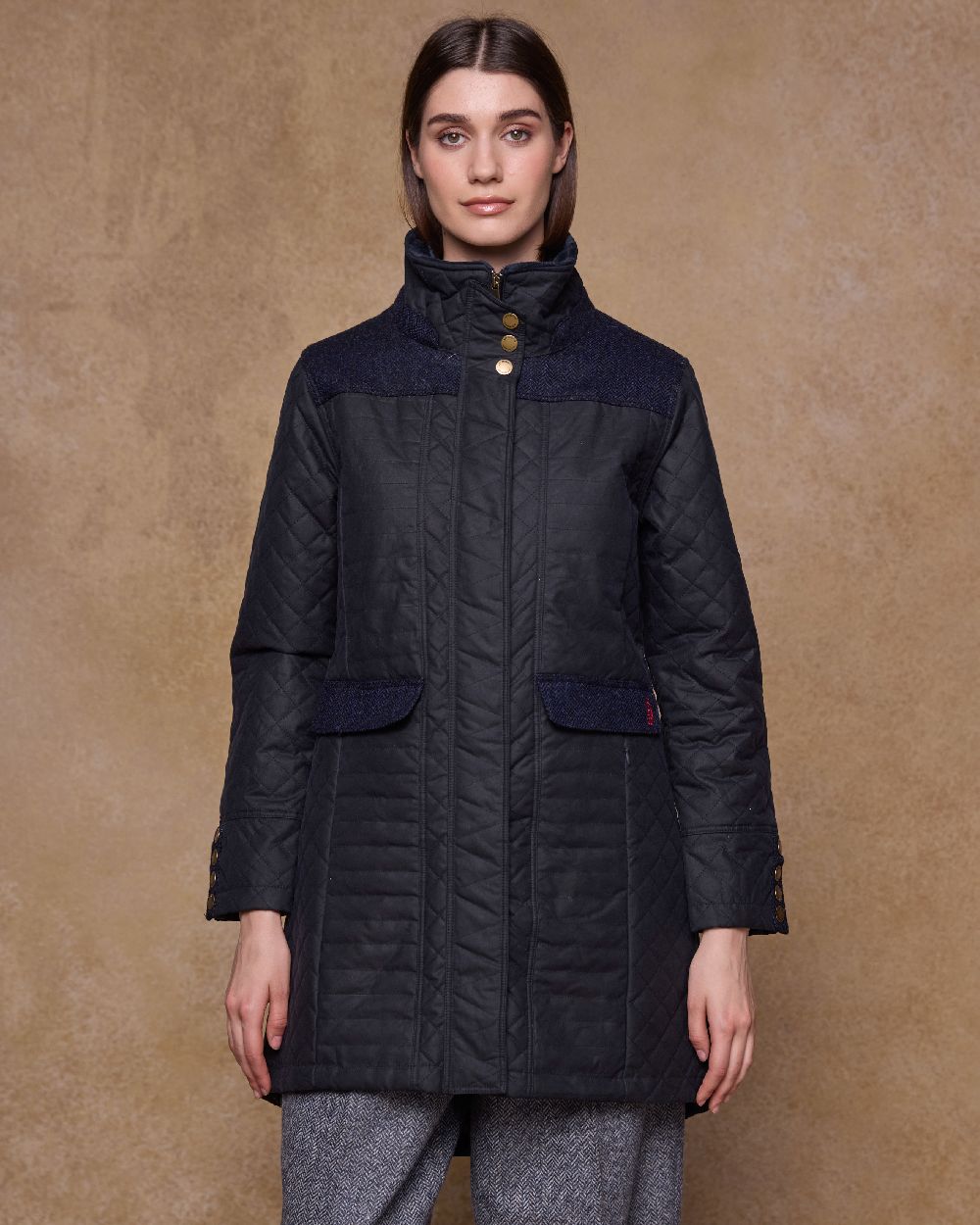 Navy Coloured Jack Murphy Jodie Wax Coat on indoor background 