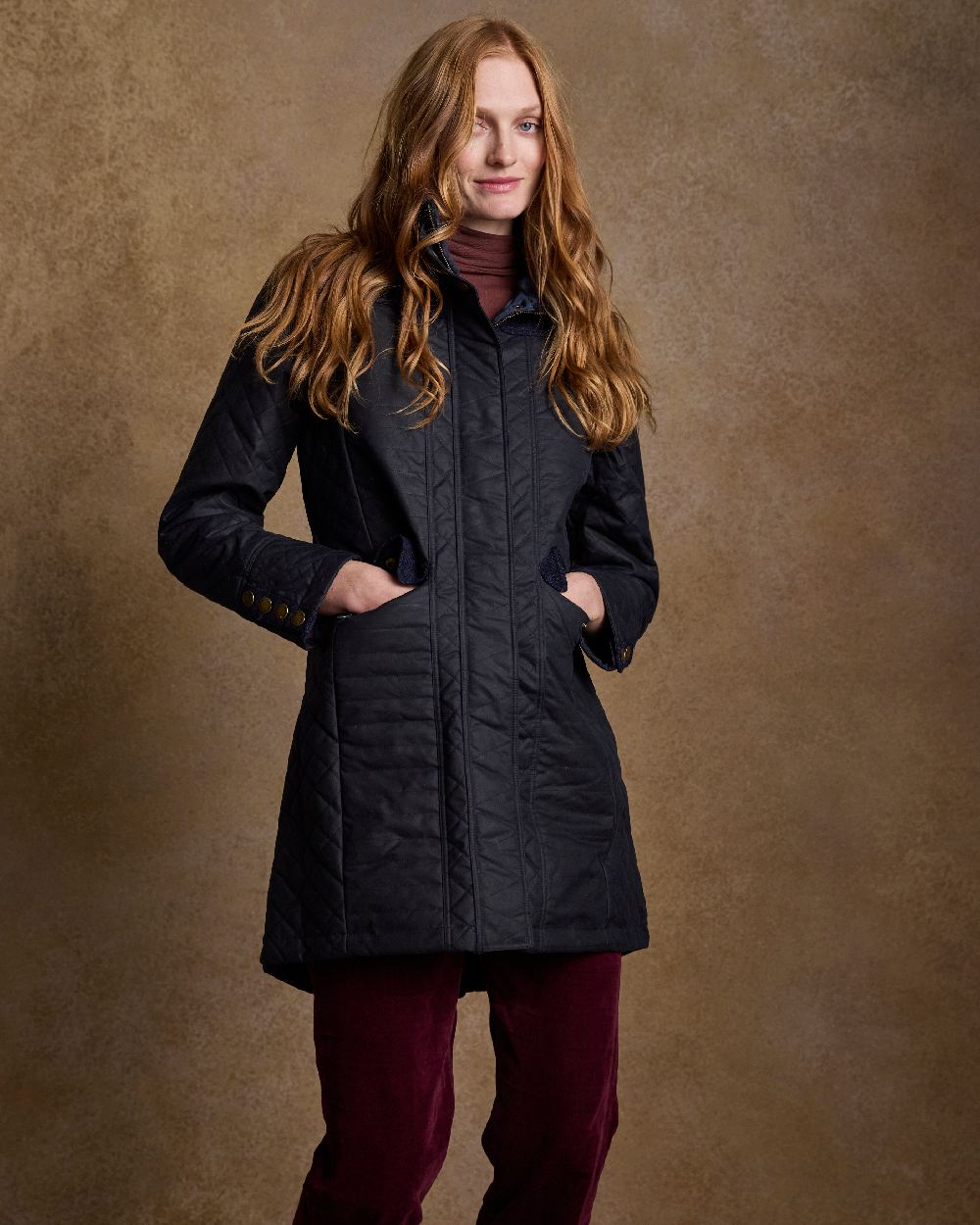 Navy Coloured Jack Murphy Jodie Wax Coat on indoor background 