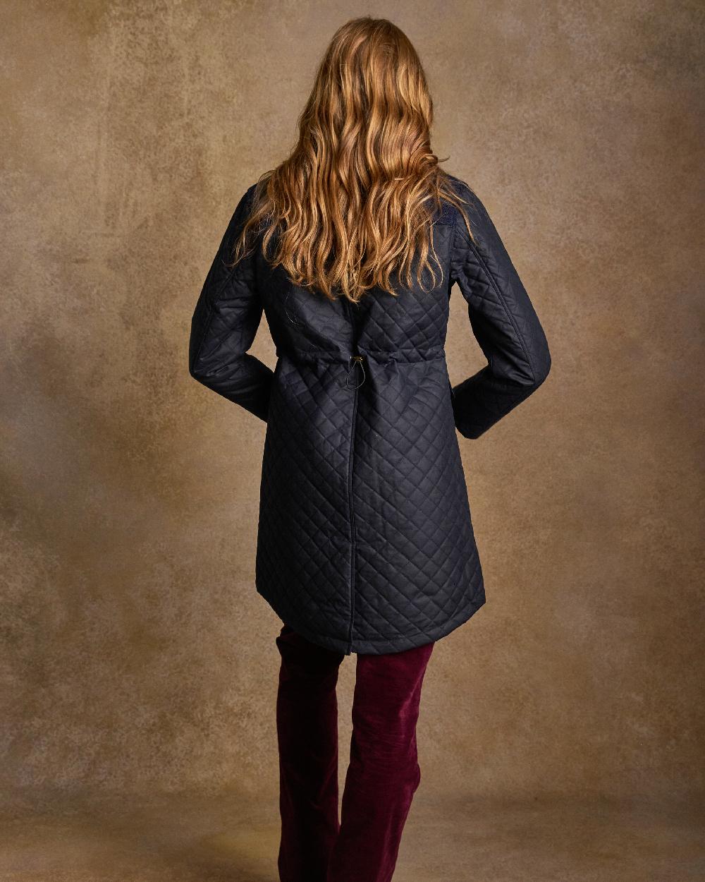 Navy Coloured Jack Murphy Jodie Wax Coat on indoor background 