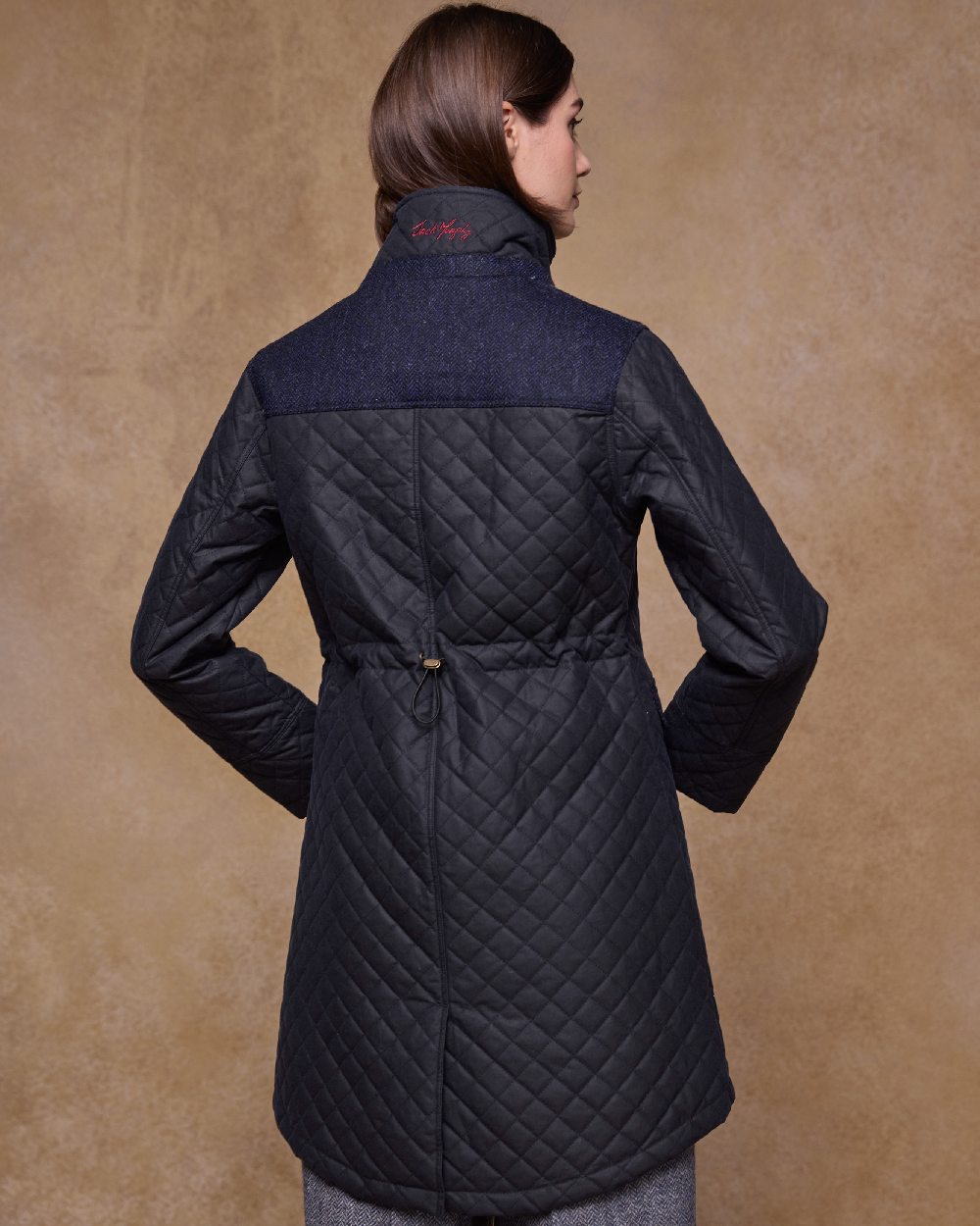 Navy Coloured Jack Murphy Jodie Wax Coat on indoor background 