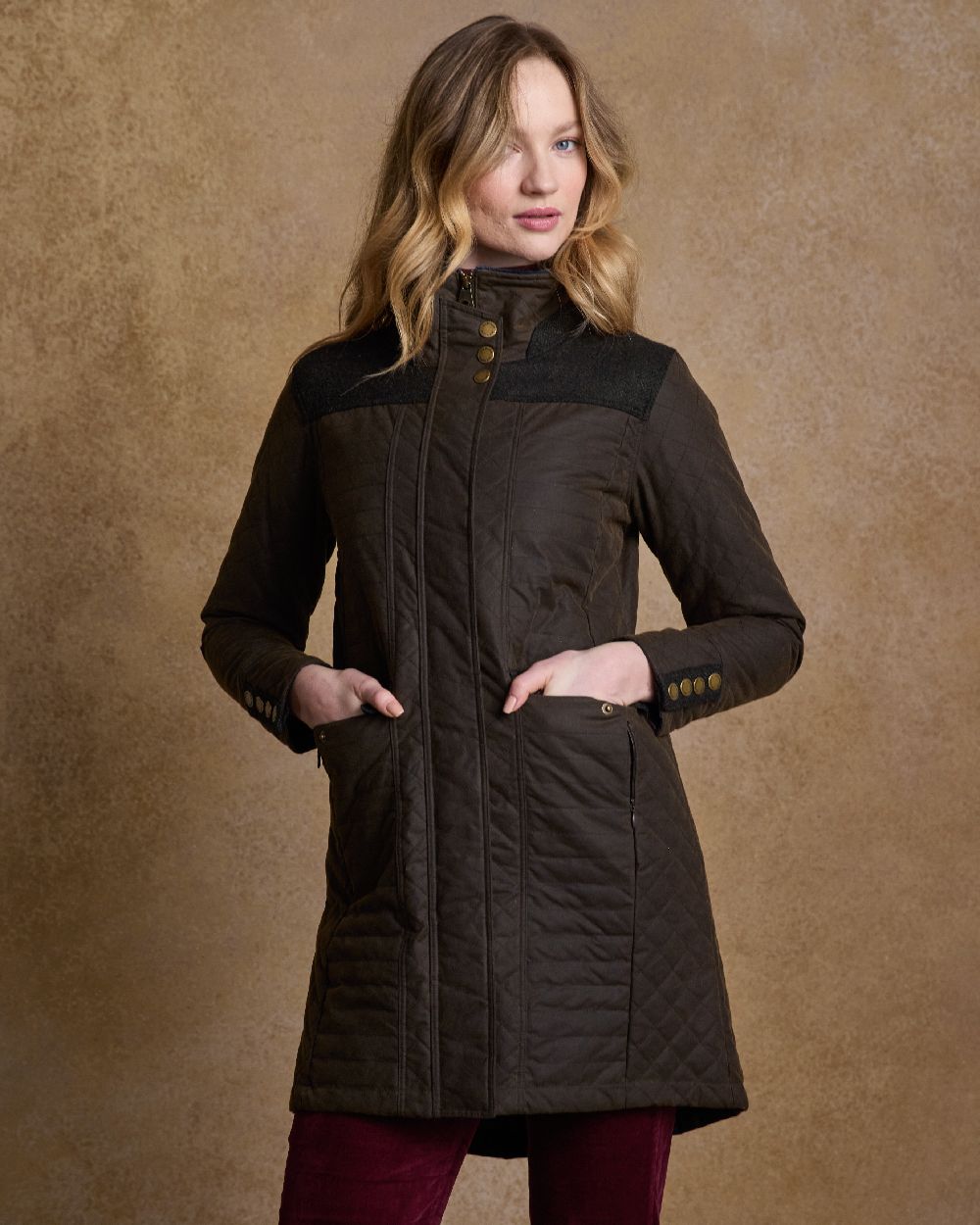 Olive Coloured Jack Murphy Jodie Wax Coat on indoor background 