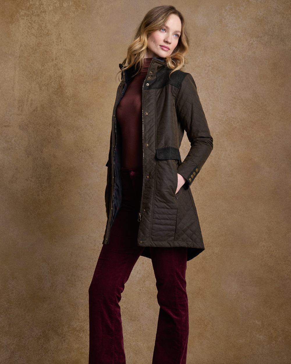 Olive Coloured Jack Murphy Jodie Wax Coat on indoor background 