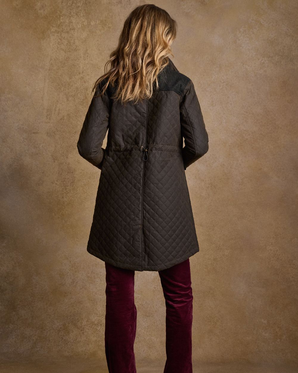 Olive Coloured Jack Murphy Jodie Wax Coat on indoor background 