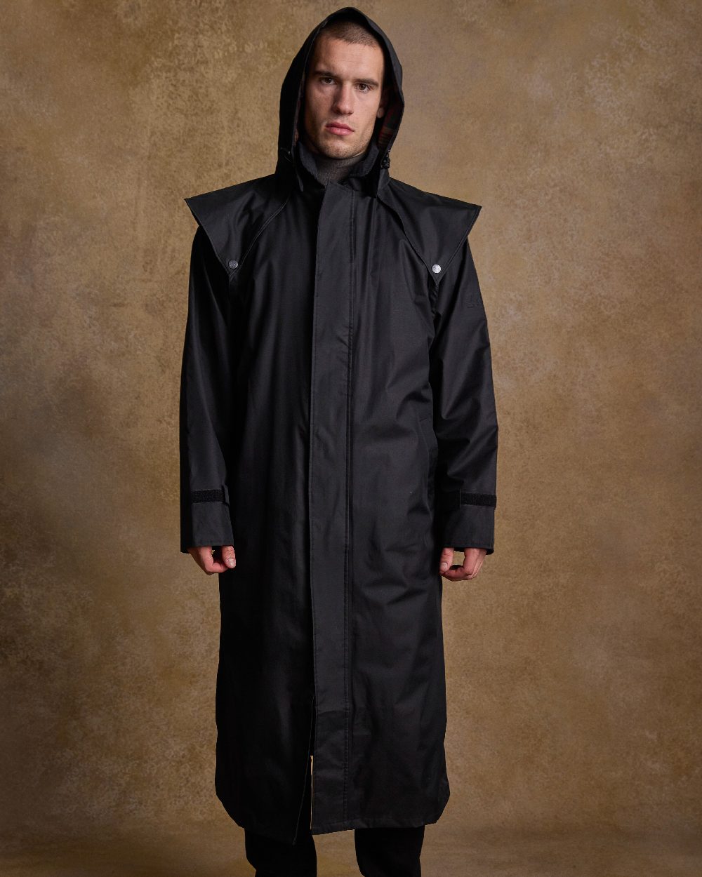 Black Coloured Jack Murphy Lambourne Mens Long Bush Coat on indoor background 