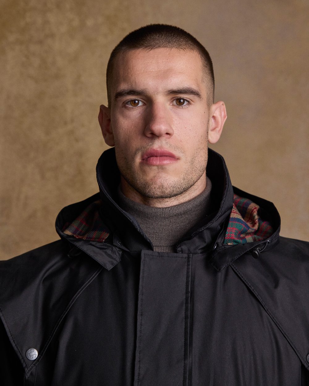 Black Coloured Jack Murphy Lambourne Mens Long Bush Coat on indoor background 