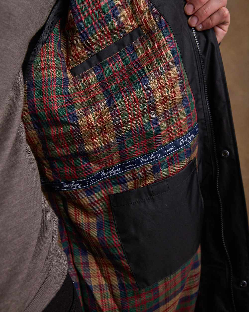 Black Coloured Jack Murphy Lambourne Mens Long Bush Coat on indoor background 