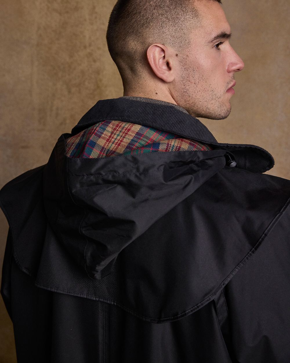 Black Coloured Jack Murphy Lambourne Mens Long Bush Coat on indoor background 
