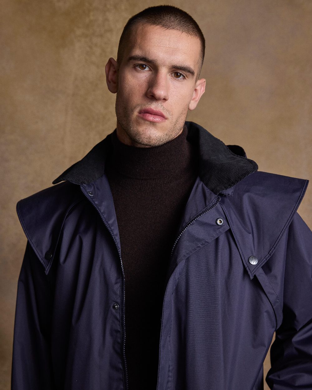 Navy Coloured Jack Murphy Lambourne Mens Long Bush Coat on indoor background 
