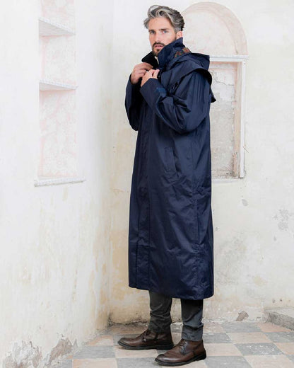 Navy coloured Jack Murphy Lambourne Mens Long Bush Coat on wall background 