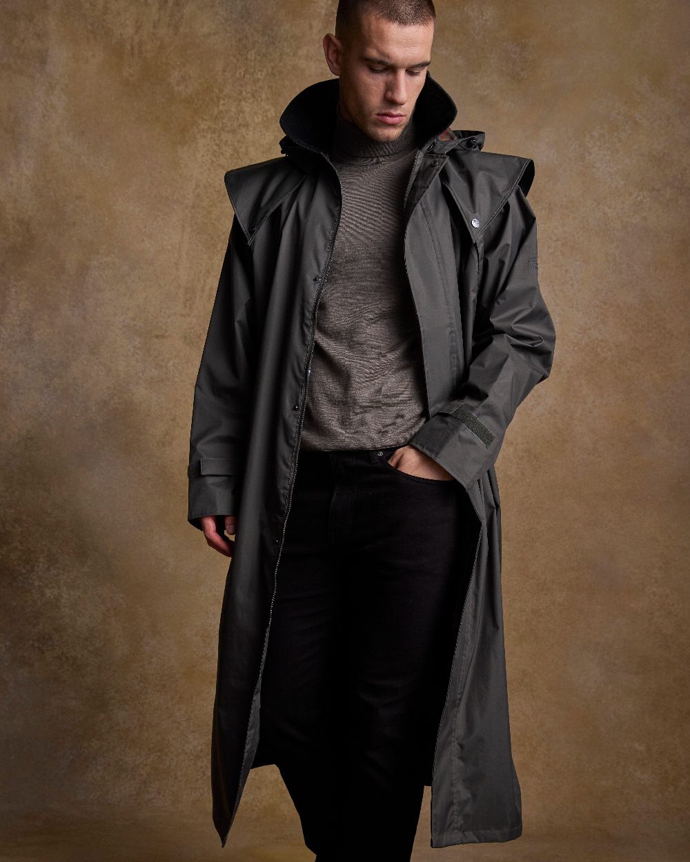 Olive Coloured Jack Murphy Lambourne Mens Long Bush Coat on indoor background 
