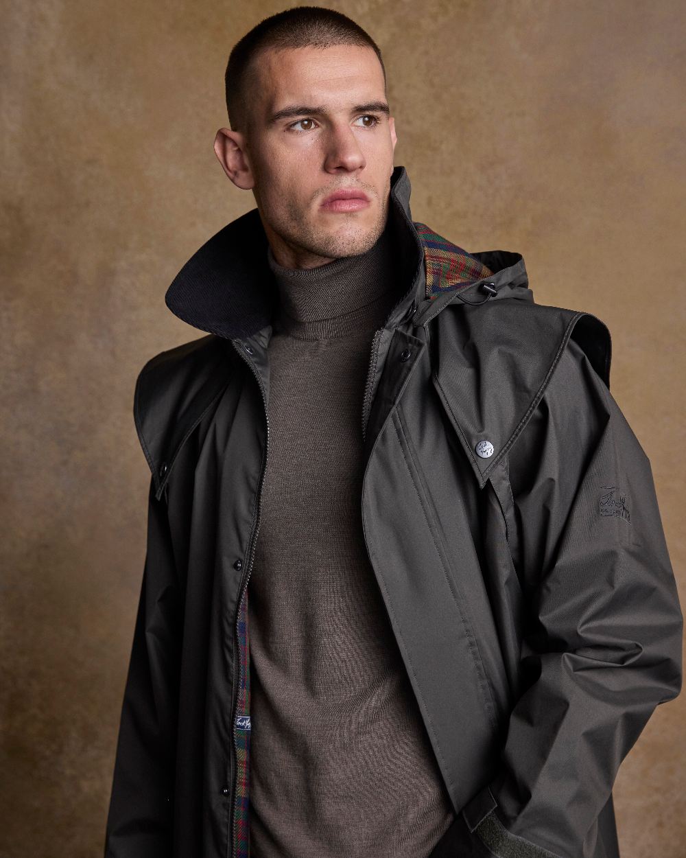 Olive Coloured Jack Murphy Lambourne Mens Long Bush Coat on indoor background 