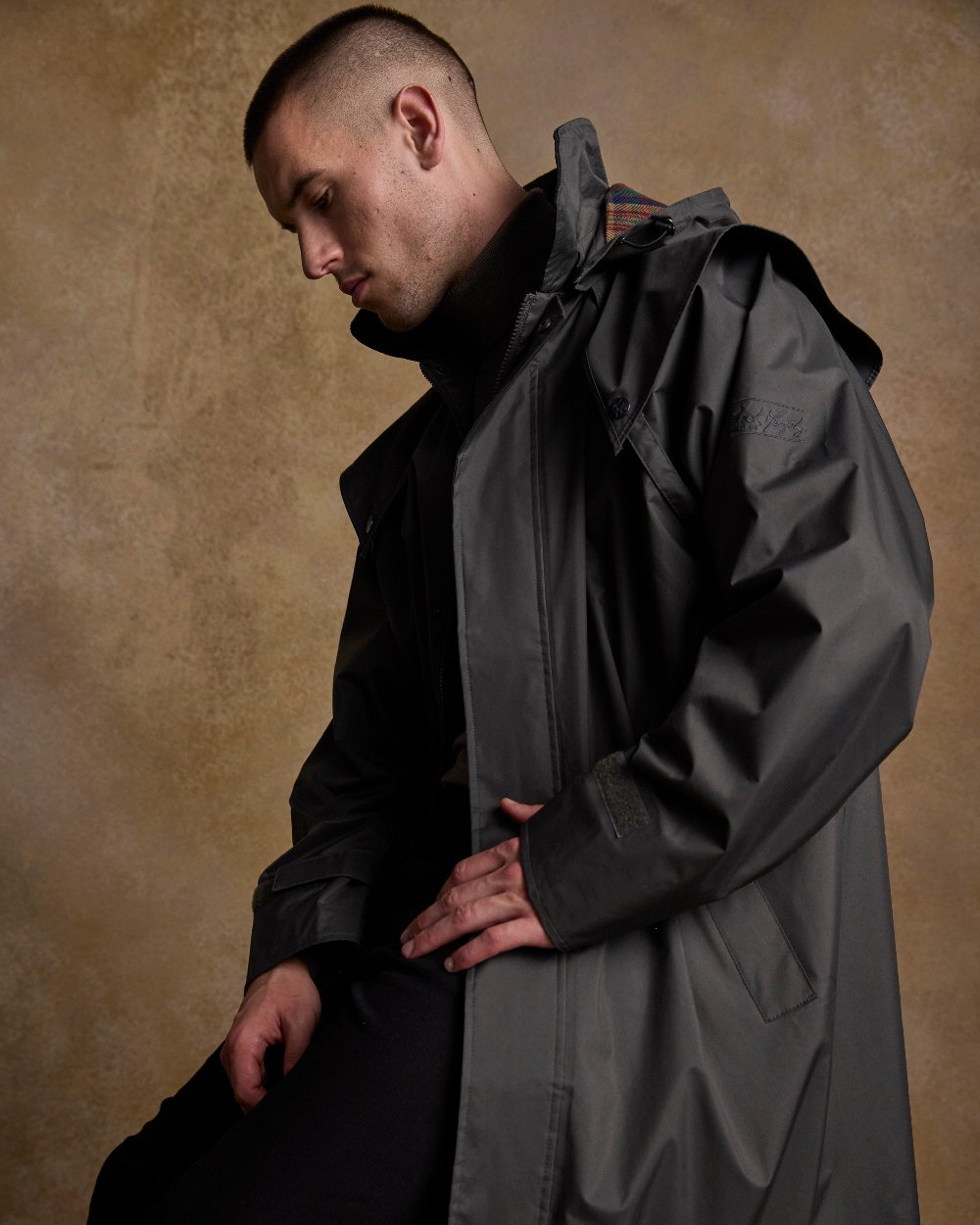 Olive Coloured Jack Murphy Lambourne Mens Long Bush Coat on indoor background 