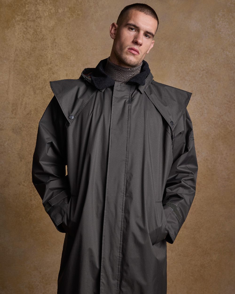 Olive Coloured Jack Murphy Lambourne Mens Long Bush Coat on indoor background 