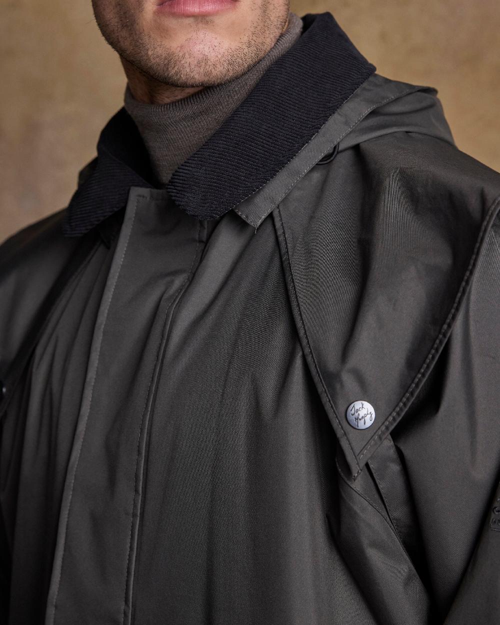 Olive Coloured Jack Murphy Lambourne Mens Long Bush Coat on indoor background 