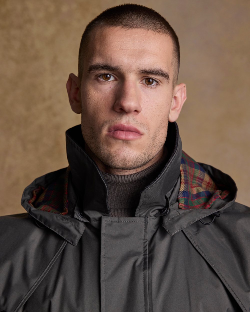 Olive Coloured Jack Murphy Lambourne Mens Long Bush Coat on indoor background 