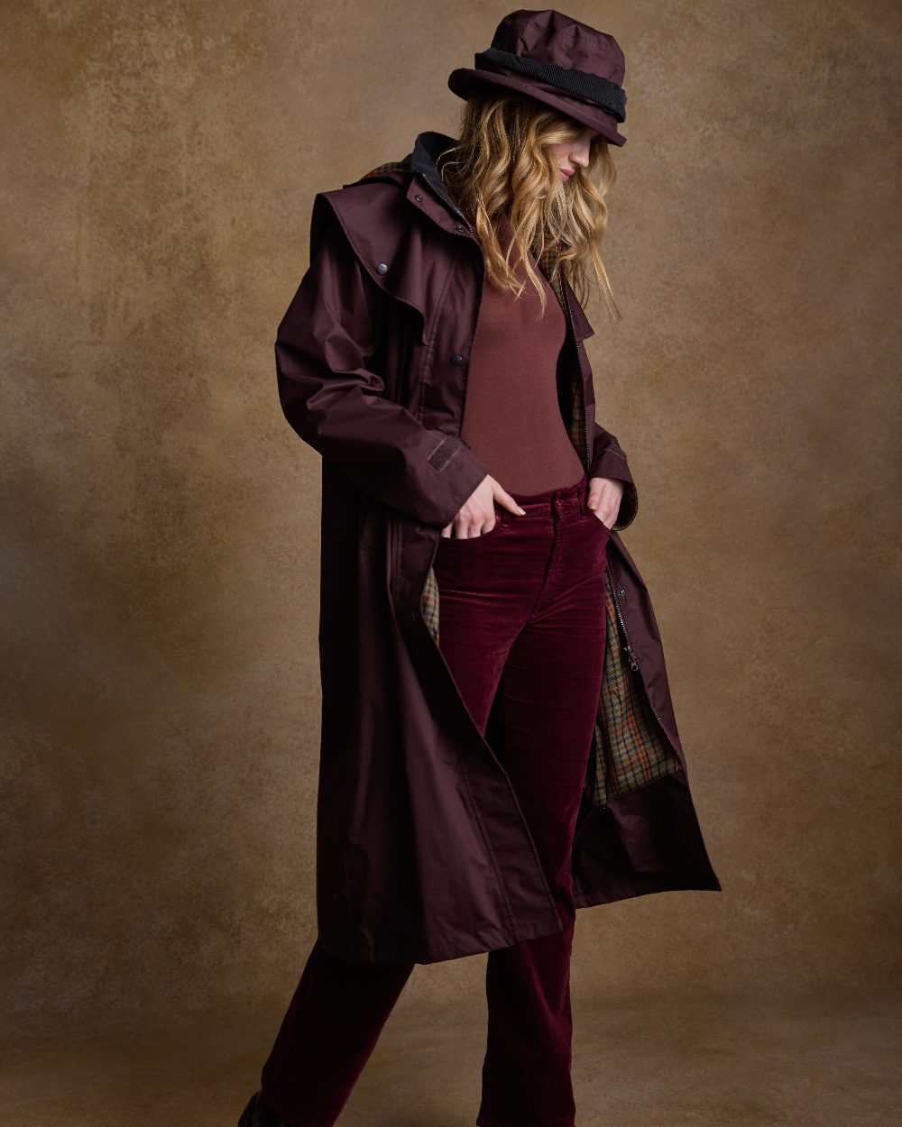 Deep Claret Coloured Jack Murphy Malvern Ladies Waterproof Bush Coat on indoor background 