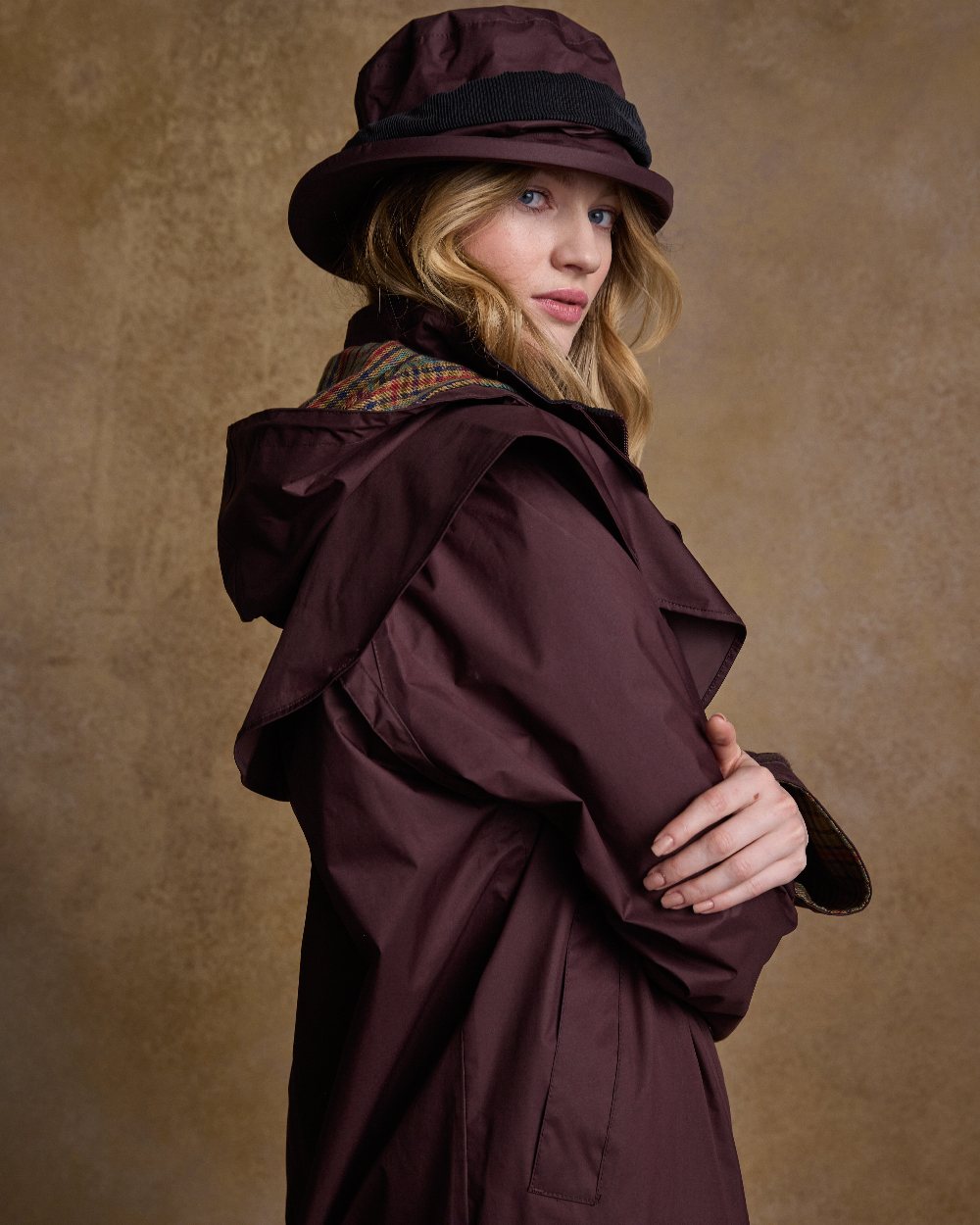 Deep Claret Coloured Jack Murphy Malvern Ladies Waterproof Bush Coat on indoor background 