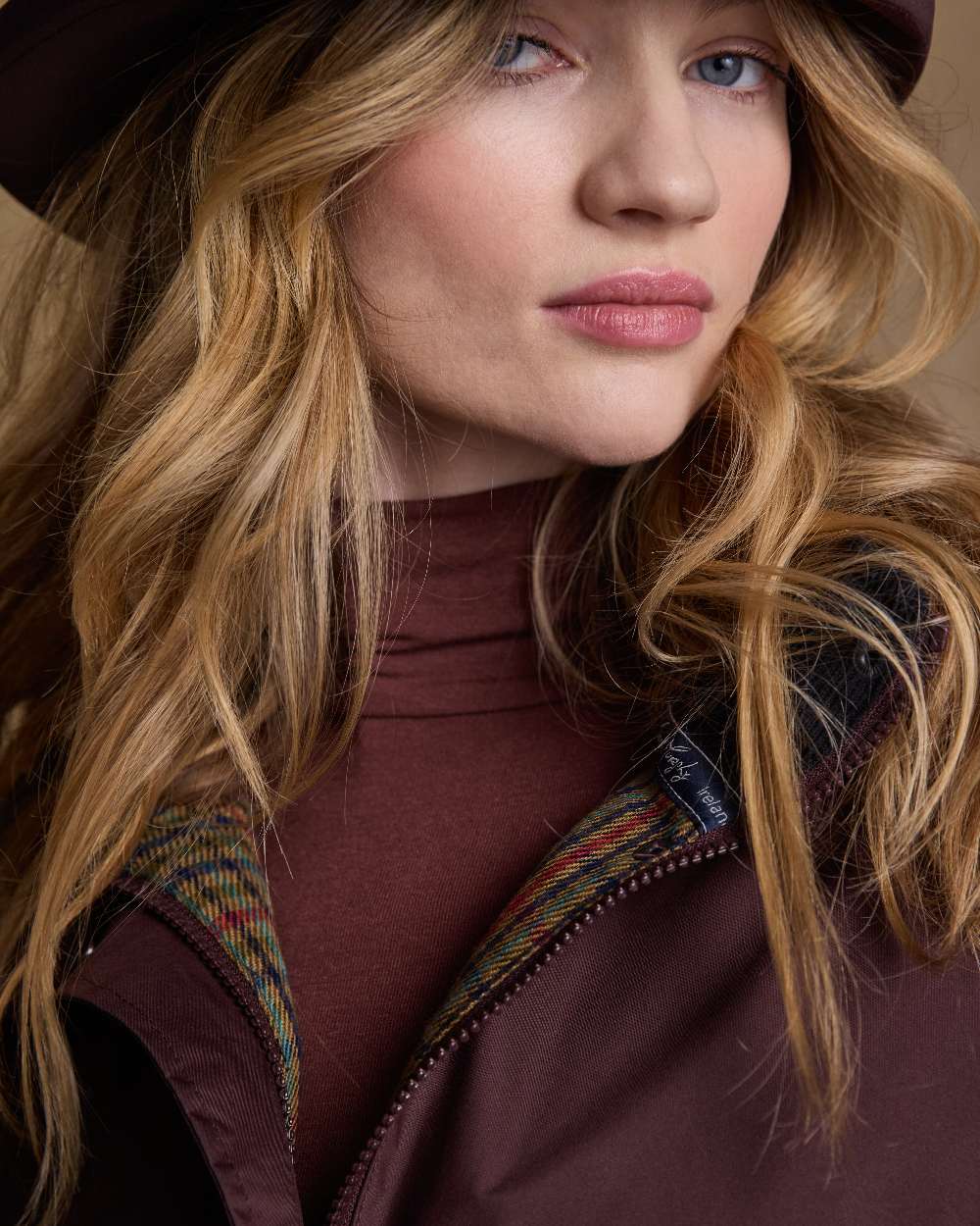 Deep Claret Coloured Jack Murphy Malvern Ladies Waterproof Bush Coat on indoor background 