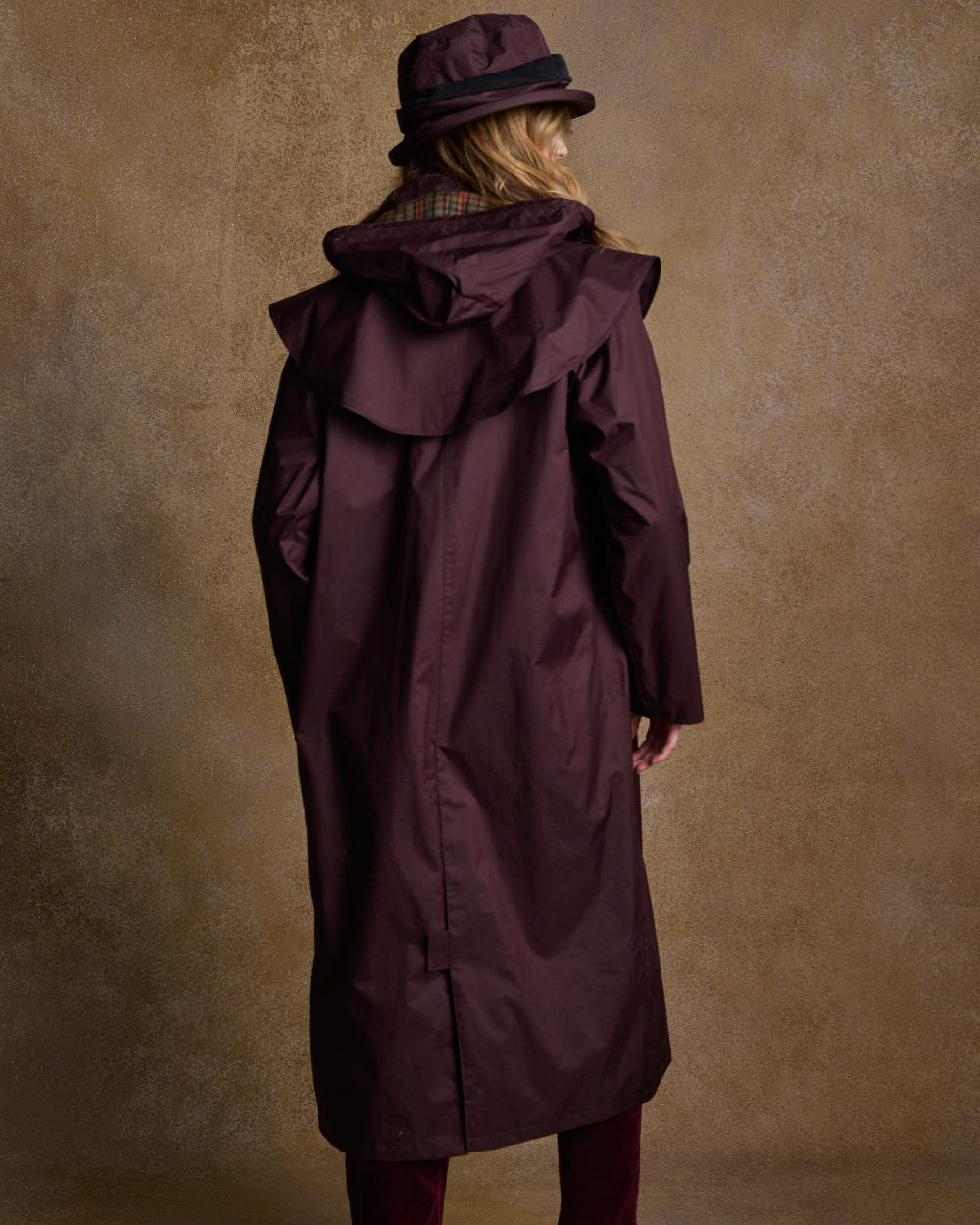 Deep Claret Coloured Jack Murphy Malvern Ladies Waterproof Bush Coat on indoor background 