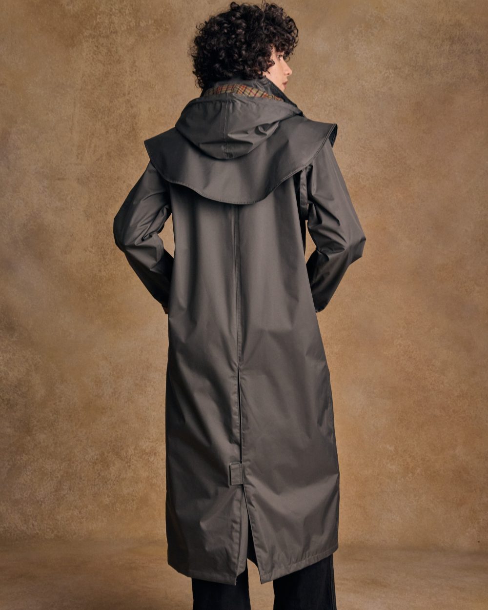 Olive coloured Jack Murphy Malvern Ladies Waterproof Bush Coat on wall background 